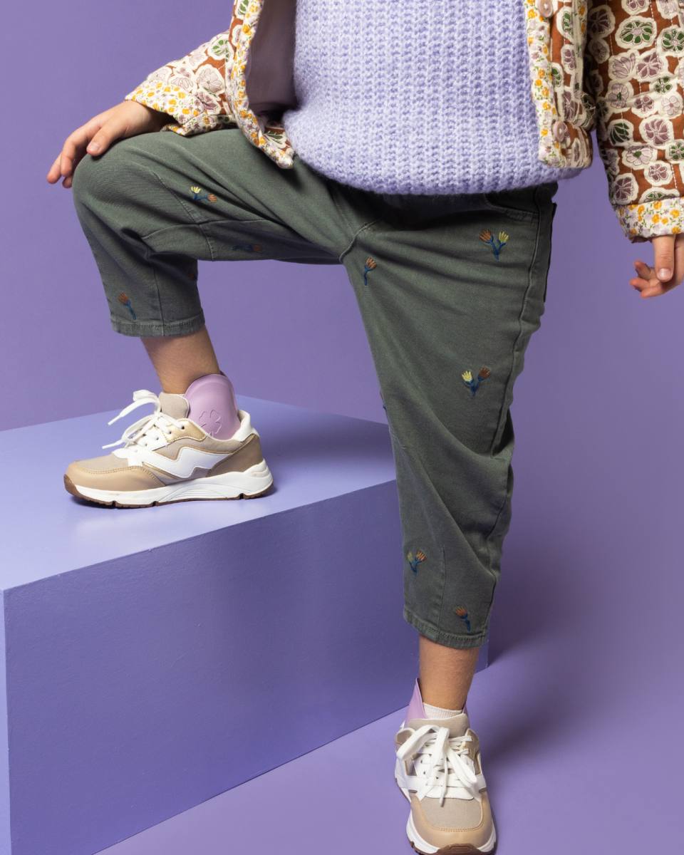 Child wearing SMO orthotic braces while walking and playing